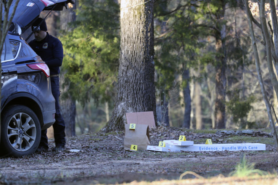 FILE - Law enforcement personnel investigate the scene of a mass shooting on Arkabutla Dam Road in Arkabutla, Miss on Friday, Feb. 17, 2023. A 52-year-old man shot and killed six people including his ex-wife and stepfather at multiple locations in a tiny rural community, authorities said. The man was armed with a shotgun and two handguns. A family friend said he had a history of mental illness. One victim was shot and killed while sitting in a pickup truck outside a convenience store. (AP Photo/Nikki Boertman, File)