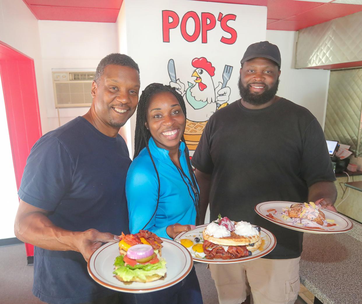 Keith Brewer, left, his wife, Shatanie Brewer, and Amos Coleman opened Pop's Chicken & Waffles in Barberton last week.