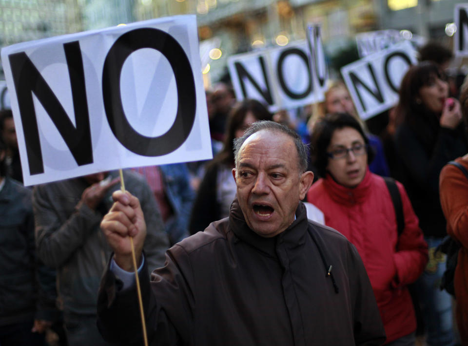 Protestors shout slogans against austerity measures announced by the Spanish government as they march to the Parliament in Madrid, Spain, Saturday, Oct. 27, 2012. Prime Minister Mariano Rajoy's government has hiked taxes, cut spending, including a wage-cut for civil servants, and introduced stinging labor reforms in a bid to persuade investors and international authorities that he can manage Spain's finances without the need for a full-blown bailout. However, Spain's public finances have been overwhelmed by the cost of rescuing some of its banks and regional governments, many of which have experienced heavy losses following a property sector crash in 2008. One Spaniard in four is unemployed as the economic crisis tightens its grip. (AP Photo/Andres Kudacki)