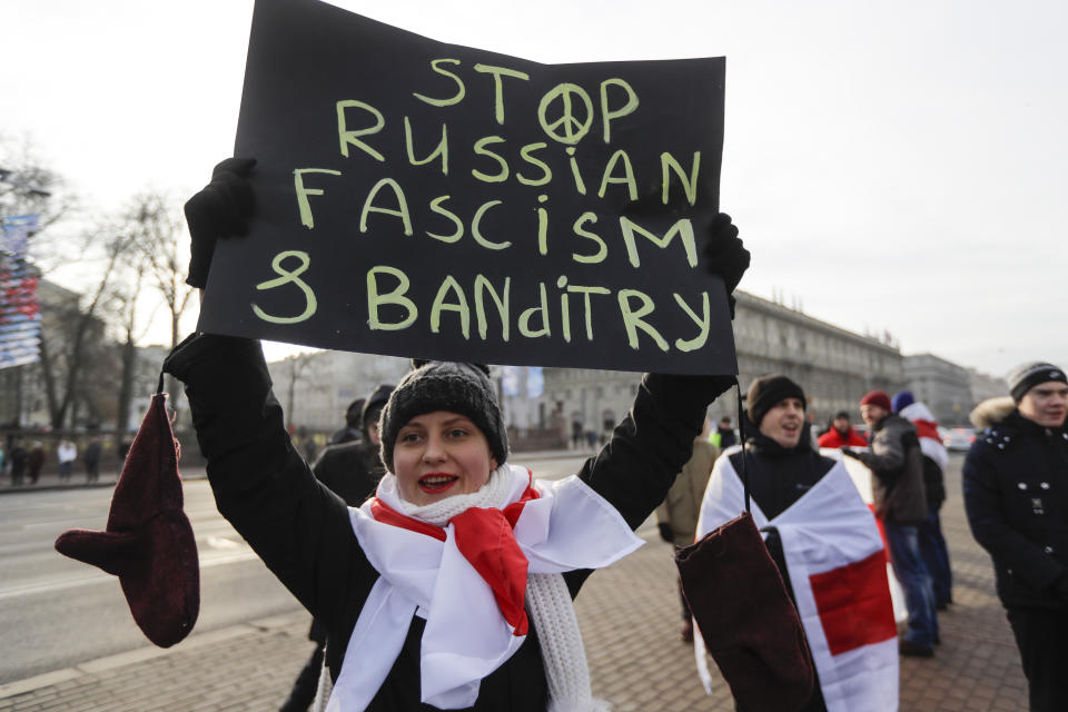 A protester holds a banner during a rally in downtown Minsk, Belarus, Saturday, Dec. 7, 2019. Several hundreds demonstrators gathered to protest against closer integration with Russia. (AP Photo/Sergei Grits)