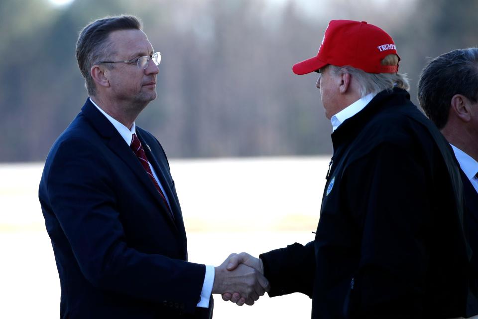President Donald Trump greets Rep. Doug Collins, R-Ga., as he arrives on Air Force One Friday, March 6, 2020, at Dobbins Air Reserve Base in Marietta, Ga.