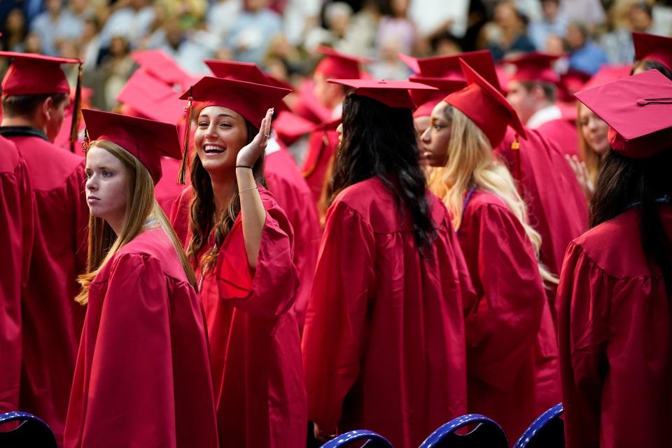 Graduating seniors wave to their families during the Ravenwood High School class of 2023 commencement ceremony at the Curb Event Center in Nashville, Tenn., Saturday, May 27, 2023.