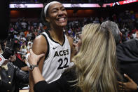 Las Vegas Aces head coach Becky Hammon, right, celebrates with Las Vegas Aces' A'ja Wilson after their win in the WNBA basketball finals against the Connecticut Sun, Sunday, Sept. 18, 2022, in Uncasville, Conn. (AP Photo/Jessica Hill)