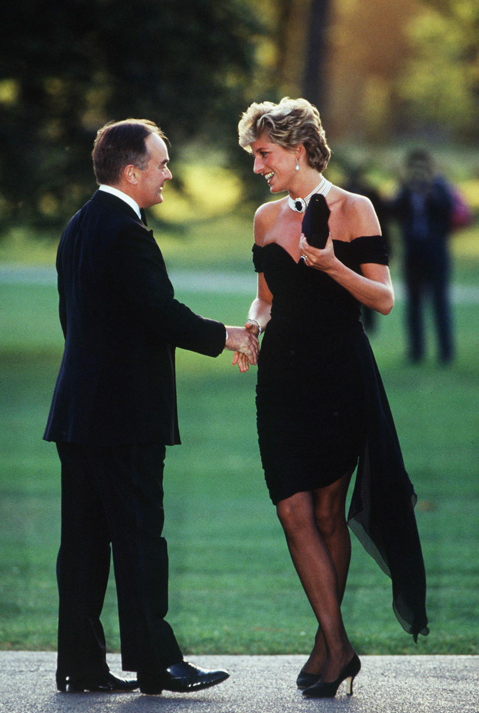 LONDON, UNITED KINGDOM - JUNE 29:  Princess Diana Wearing A Short Black Dress Designed By Christina Stambolian For A Gala At The Serpentine Gallery In London. She Is Being Greeted By Lord Palumbo.  (Photo by Tim Graham Photo Library via Getty Images)