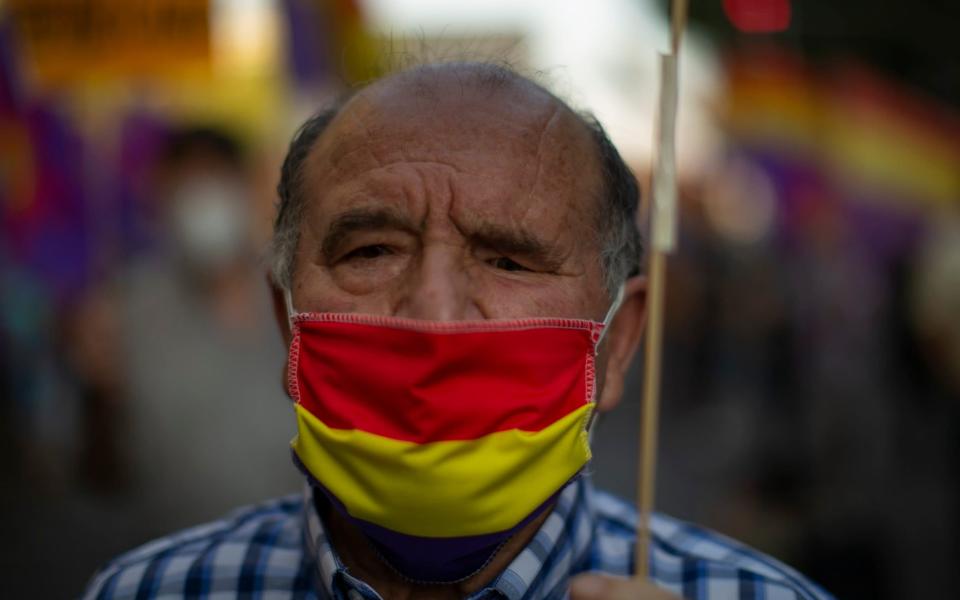 A Spanish man wears a face mask to prevent the spread of coronavirus - AP