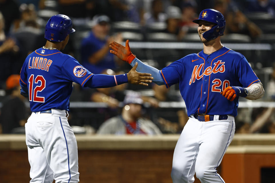 New York Mets' Francisco Lindor (12) celebrates Pete Alonso's (20) two-run home run against the Chicago Cubs during the third inning of a baseball game, Monday, Aug.7, 2023, in New York. (AP Photo/Rich Schultz)