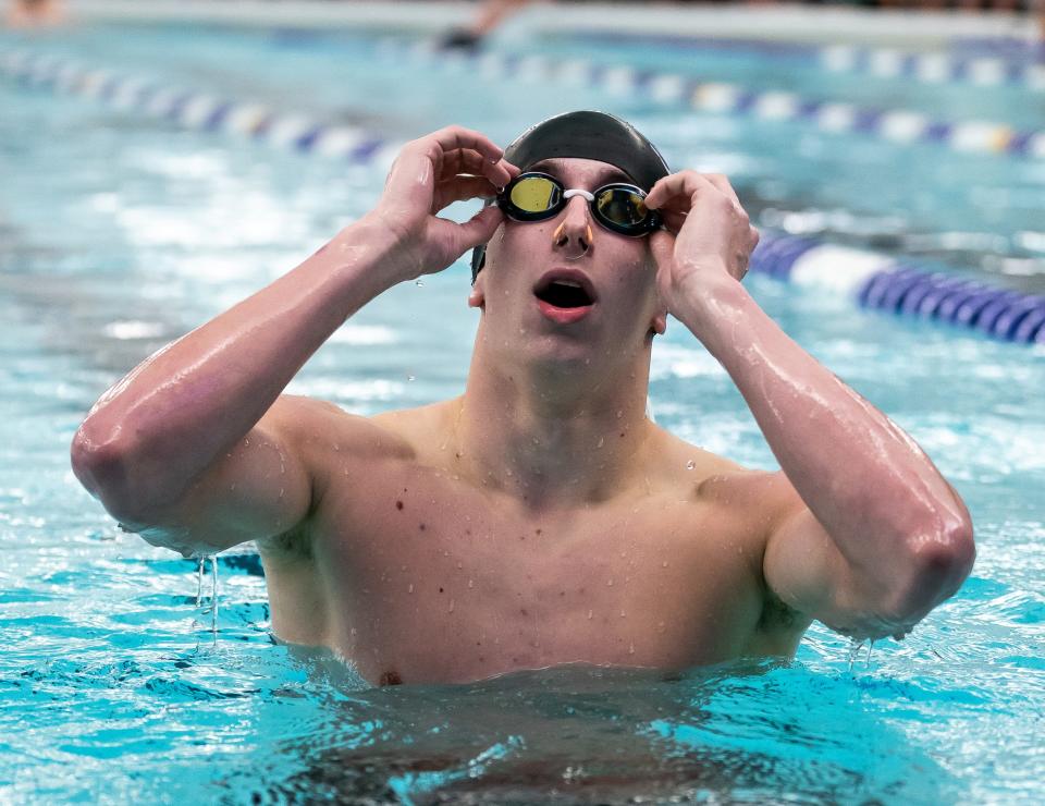 South's David Kovacs checks the results of the 200 Yard Individual Medley race during the 2024 Counsilman Classic Swimming & Diving Meet between the Bloomington North Cougars and Bloomington South Panthers at Bloomington High School South Natatorium on January 13, 2024