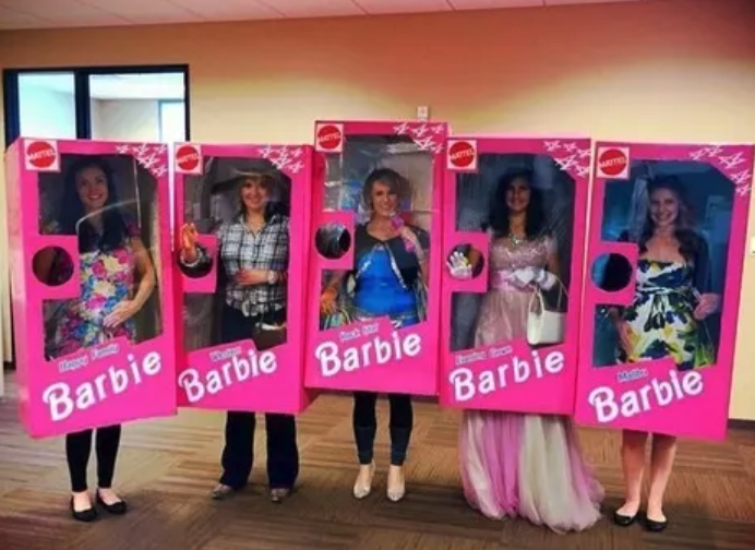 A bunch of people in pink Barbie boxes