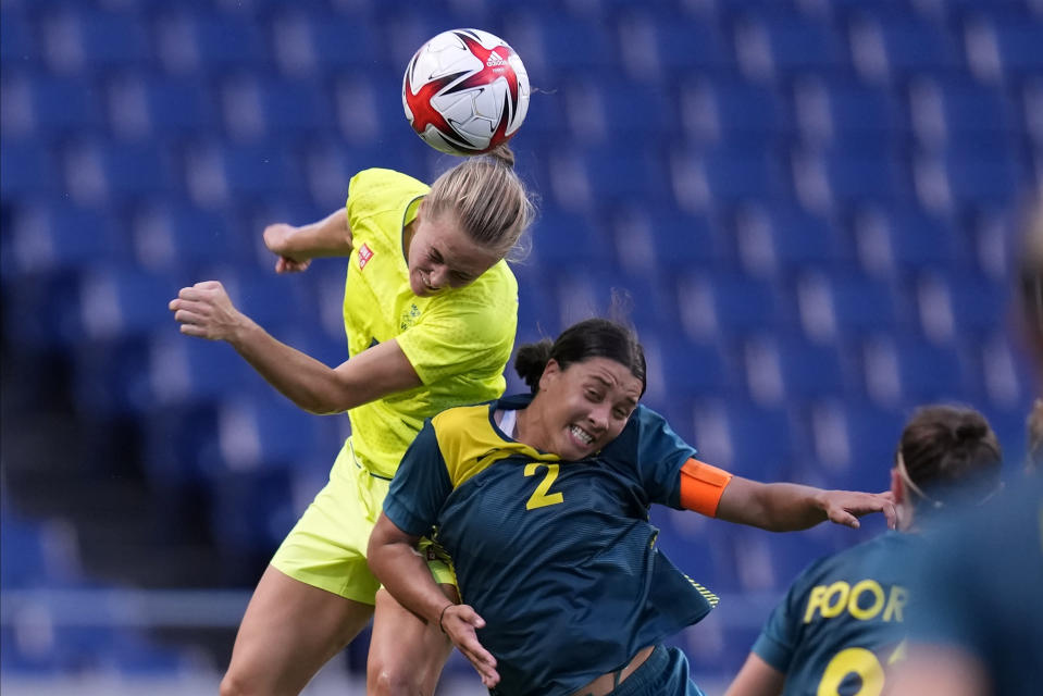 Sweden's Magdalena Eriksson goes for a header against Australia's Sam Kerr (2) during a women's soccer match at the 2020 Summer Olympics, Saturday, July 24, 2021, in Saitama, Japan. (AP Photo/Martin Mejia)