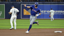 Texas Rangers' Josh Jung waves to the Texas bullpen as he circles the bases after hitting a three-run home run off Tampa Bay Rays starter Ryan Pepiot during the first inning of a baseball game Monday, April 1, 2024, in St. Petersburg, Fla. (AP Photo/Steve Nesius)