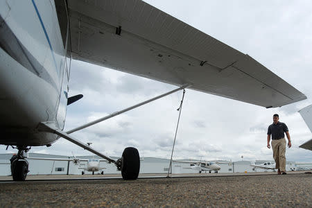 Military helicopter pilot Dominic Cipolla walks under the wing of an instruction plane at Coast Flight Training in San Diego, California, U.S., January 15, 2019. REUTERS/Mike Blake/Files