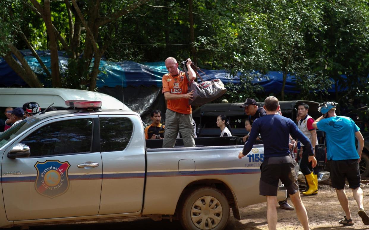 Vernon Unsworth, in orange, pictured during the rescue of the 12 Thai trapped schoolboys - REUTERS