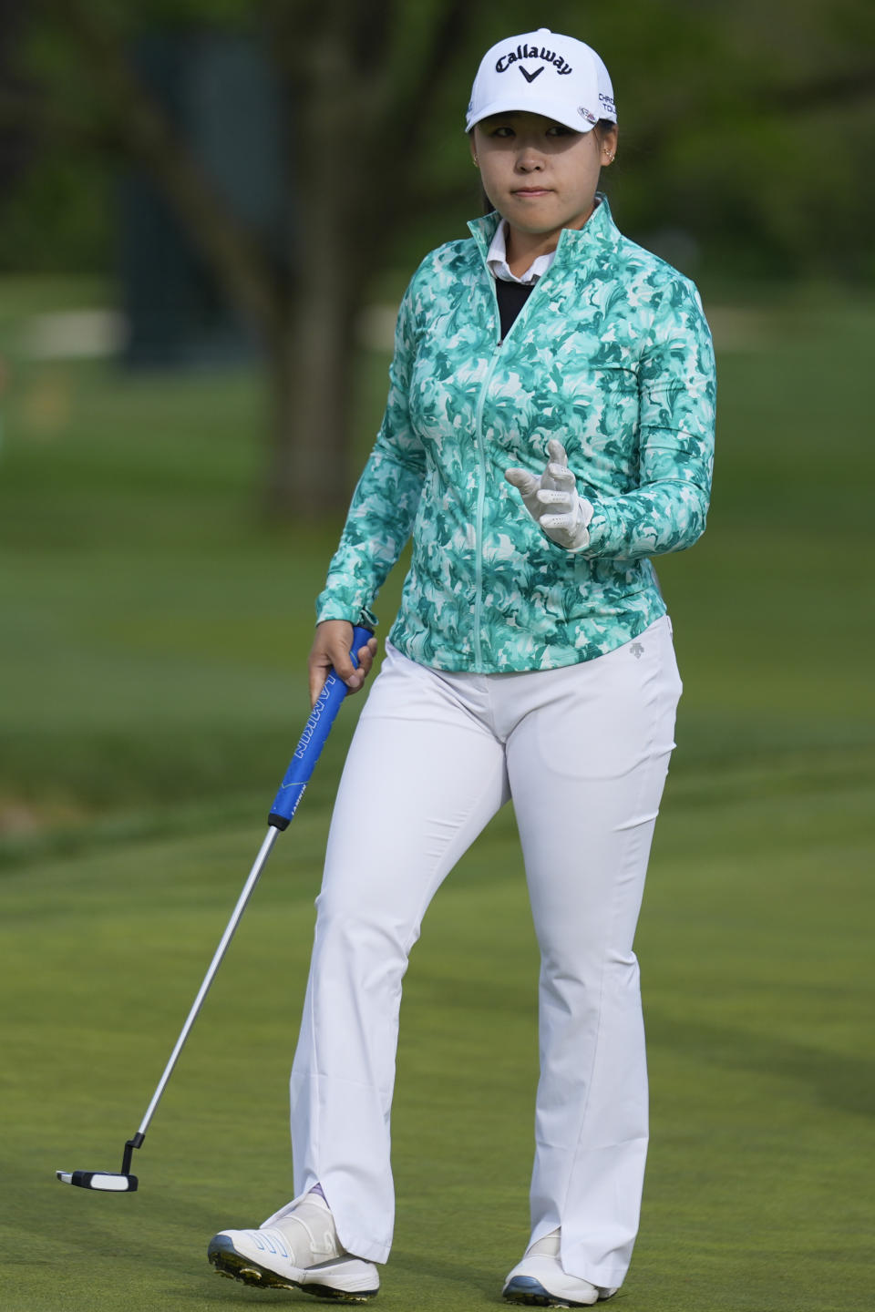 Mary Liu, of China, waves after her putt on the first hole during the first round of the LPGA Cognizant Founders Cup golf tournament, Thursday, May 9, 2024, in Clifton, N.J. (AP Photo/Seth Wenig)