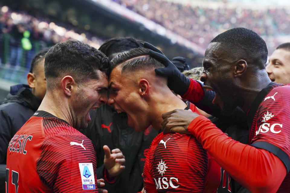 Milan's Jan Carlo Simic, centre, celebrates with teammates after scoring their side's second goal of the game during the Serie A soccer match between AC Milan and AC Monza at San Siro stadium in Milan, Italy, Sunday Dec. 17, 2023. (Spada/LaPresse via AP)