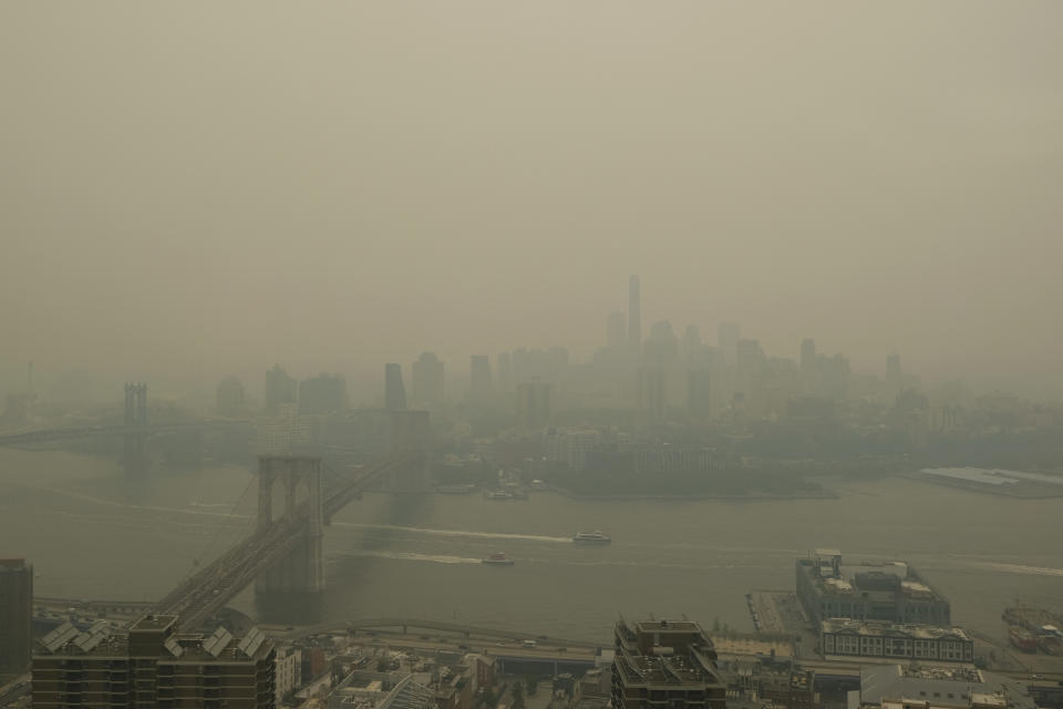 In a view toward Brooklyn, boats maneuver the East River near the Manhattan Bridge, left, and Brooklyn Bridge in New York on Wednesday, June 7, 2023. (AP Photo/Alyssa Goodman)