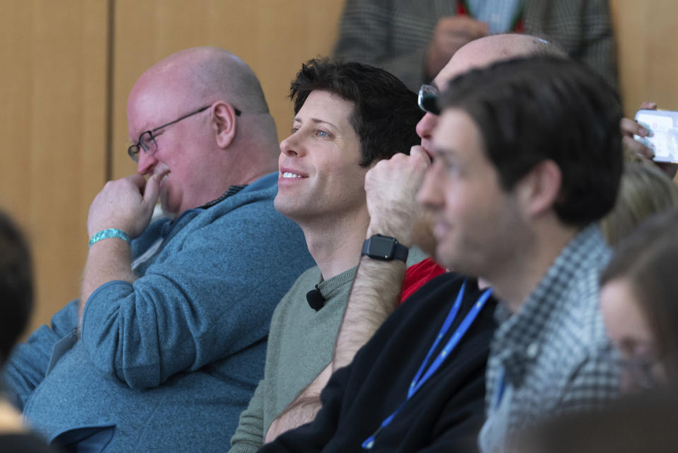 OpenAI CEO Sam Altman, second from left, watches a presentation introducing the integration of the Microsoft Bing search engine and Edge browser with OpenAI on Tuesday, Feb. 7, 2023, in Redmond, Wash. Microsoft is fusing ChatGPT-like technology into its search engine Bing, transforming an internet service that now trails far behind Google into a new way of communicating with artificial intelligence. (AP Photo/Stephen Brashear)