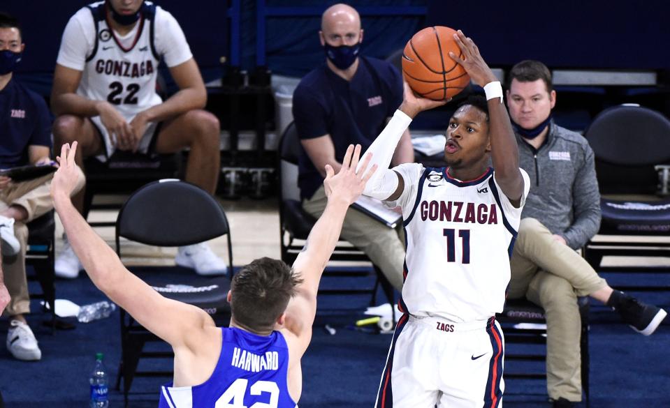 Gonzaga guard Joel Ayayi (11) puts up a shot over Brigham Young center Richard Harward in the second half of their game at McCarthey Athletic Center.
