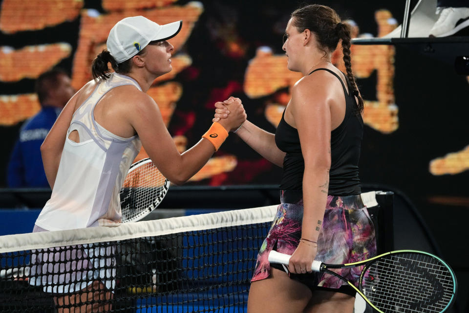 Iga Swiatek, left, of Poland is congratulated by Jule Niemeier of Germany following their first round match at the Australian Open tennis championship in Melbourne, Australia, Monday, Jan. 16, 2023. (AP Photo/Aaron Favila)