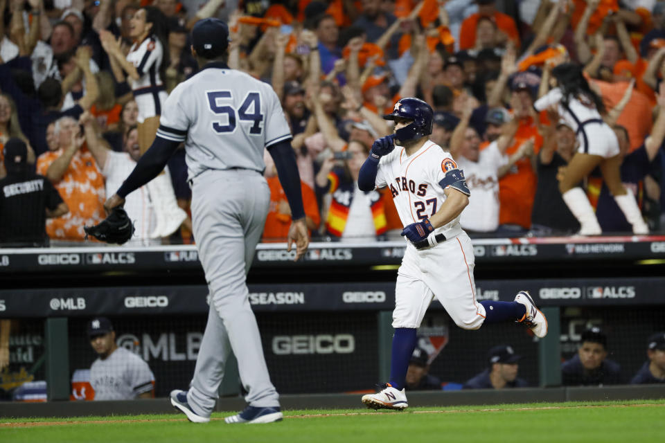Houston's Jose Altuve (27) celebrates after a walk-off home run off Yankees pitcher Aroldis Chapman to win the American League on Saturday. (AP)