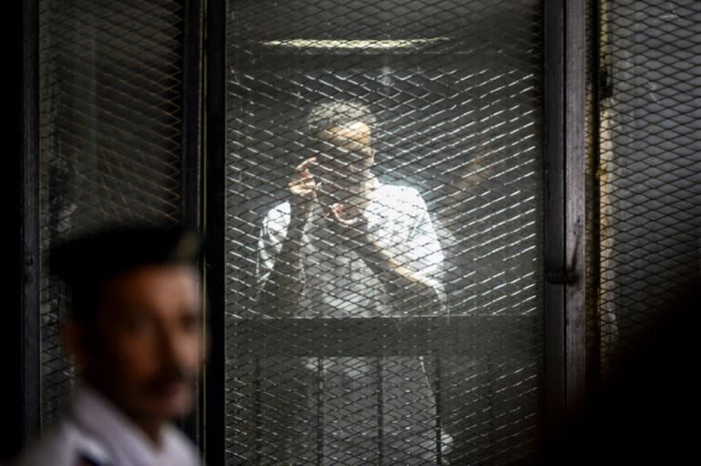Egyptian photojournalist Mahmud Abu Zeid, also known as Shawkan, in the dock during his trial in Cairo on July 28, 2018