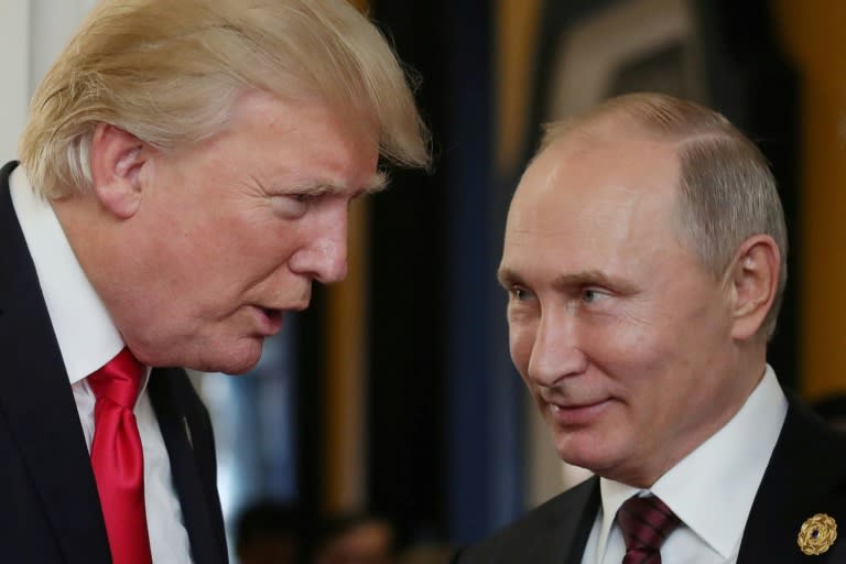 US President Donald Trump (left) chats with his Russian counterpart Vladimir Putin during an Asia-Pacific Economic Cooperation summit in the Vietnamese city of Danang on November 11, 2017