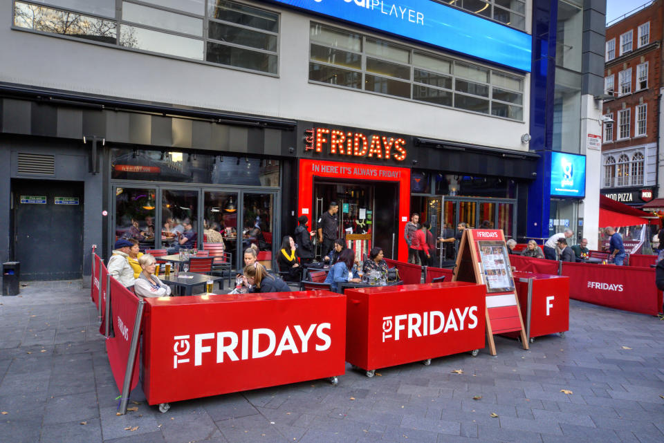 London, United Kingdom - September 7, 2019: Exterior of TGI Fridays in Leceister Square in London UK with motion blurred pedestrians and diners seated outside