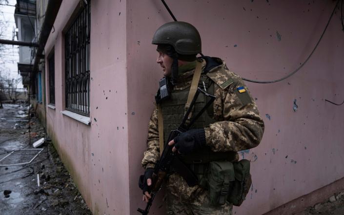 A Ukrainian marine serviceman prepares to change position during a patrol in the frontline city of Vuhledar - Evgeniy Maloletka/AP