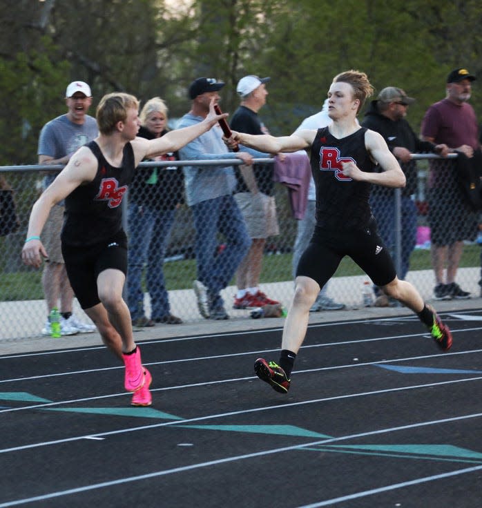 Roland-Story's Heston McIlrath (right) makes the exchange with Hesston Johnson during the boys 4x400-meter relay at the Heart of Iowa Conference co-ed track meet May 4 at Saydel High School in Des Moines.