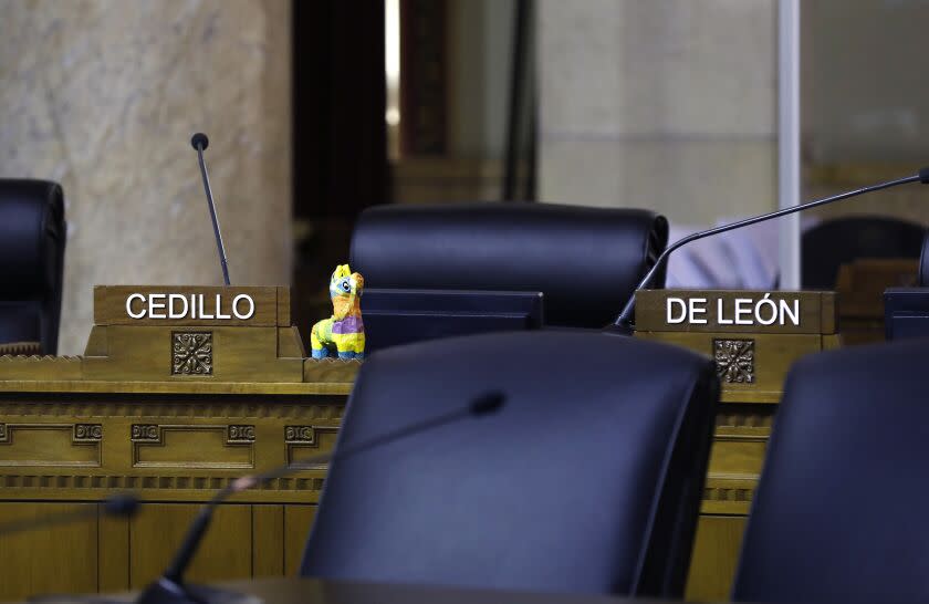 LOS ANGELES, CA - OCTOBER 12, 2022: Members of the community are calling for the resignation of Nury Martinez, Kevin de Leon and Gil Cedillo at City Hall Council chambers in downtown Los Angeles on Wednesday, October 12, 2022. Councilman Gil Cedillo and Kevin de Leon's chairs sit empty at Wednesday's city council meeting. (Christina House / Los Angeles Times)