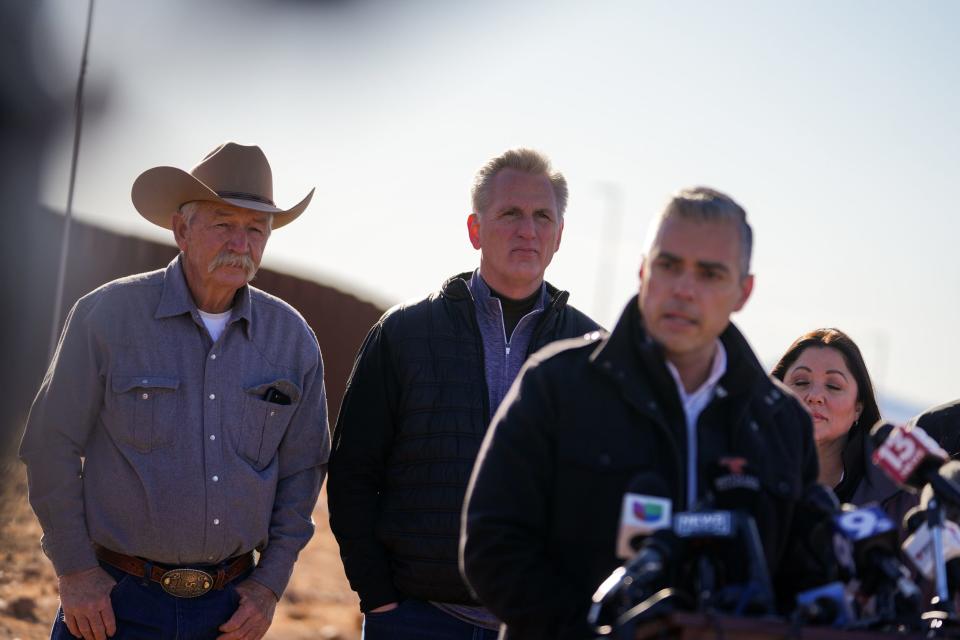 From left, John Ladd and U.S. House Speaker Kevin McCarthy listen to U.S. Rep. Juan Ciscomani (at center) speak during a news conference in front of the U.S.-Mexico border south of Sierra Vista on Feb. 16, 2023, in Hereford.