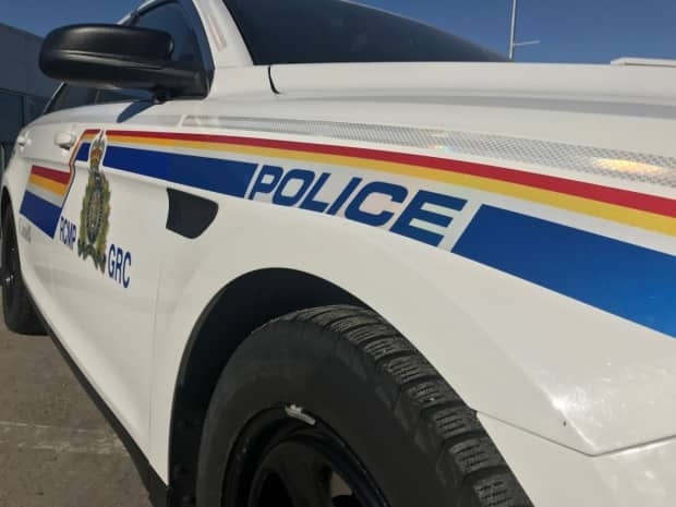 Low angle view from front of RCMP cruiser showing POLICE logo (David Bell/CBC - image credit)