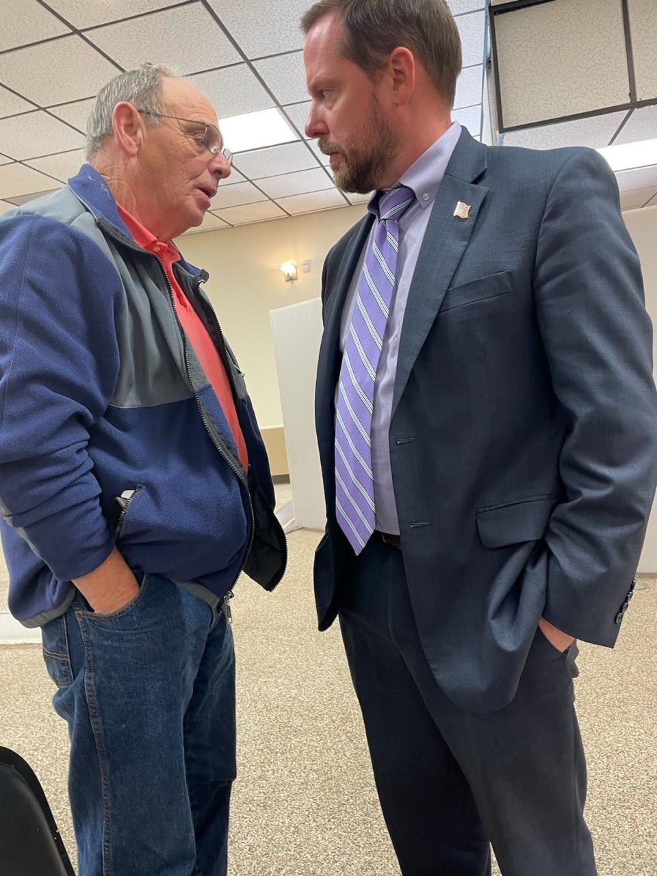 Daniel Garrett, left, speaks with Assistant District Attorney John Honeycutt in the Madison County temporary courthouse Dec. 14.