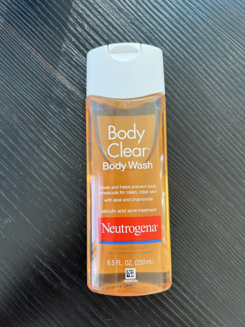 a bottle of the neutrogena body clear body wash resting on the floor