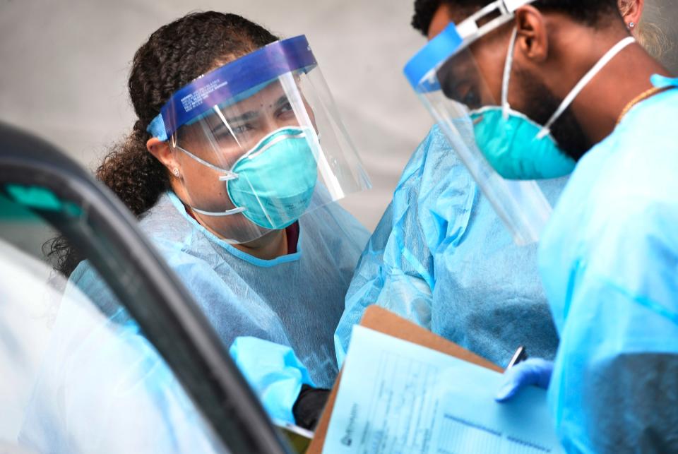 Dr. Julie Gray talks with a teammate at a COVID-19 testing site in Nashville on Aug. 11, 2020.