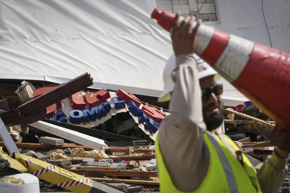 Authorities work at the scene where a tornado damaged several businesses Wednesday, April 10, 2024, in Katy, Texas. (Jon Shapley/Houston Chronicle via AP)