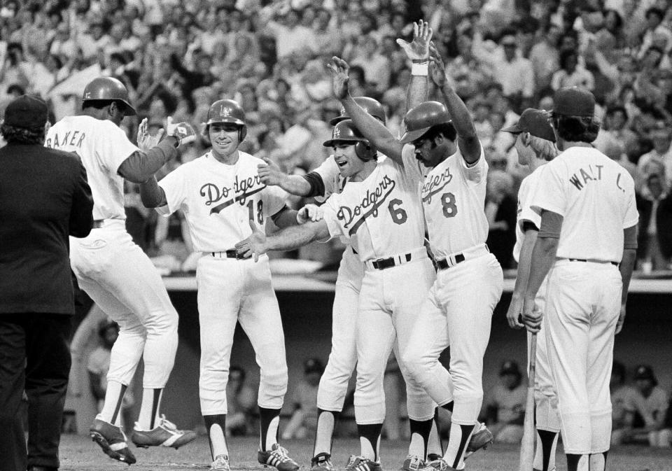 Dusty Baker is greeted, from left, by Bill Russell, Rick Monday, Steve Garvey and Reggie Smith, after hitting a grand slam.