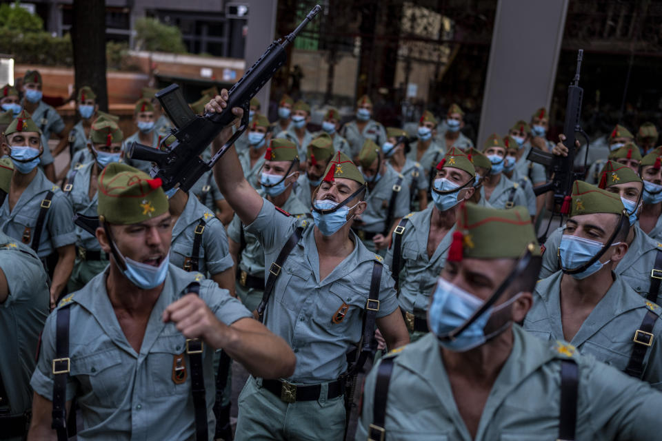 Members of La Legion, an elite unit of the Spanish Army, react before the start of a military parade celebrating a holiday known as 'Dia de la Hispanidad' or Hispanic Day in Madrid, Spain, Tuesday, Oct. 12, 2021. Spain commemorates Christopher Columbus' arrival in the New World and also Spain's armed forces day. (AP Photo/Manu Fernandez)