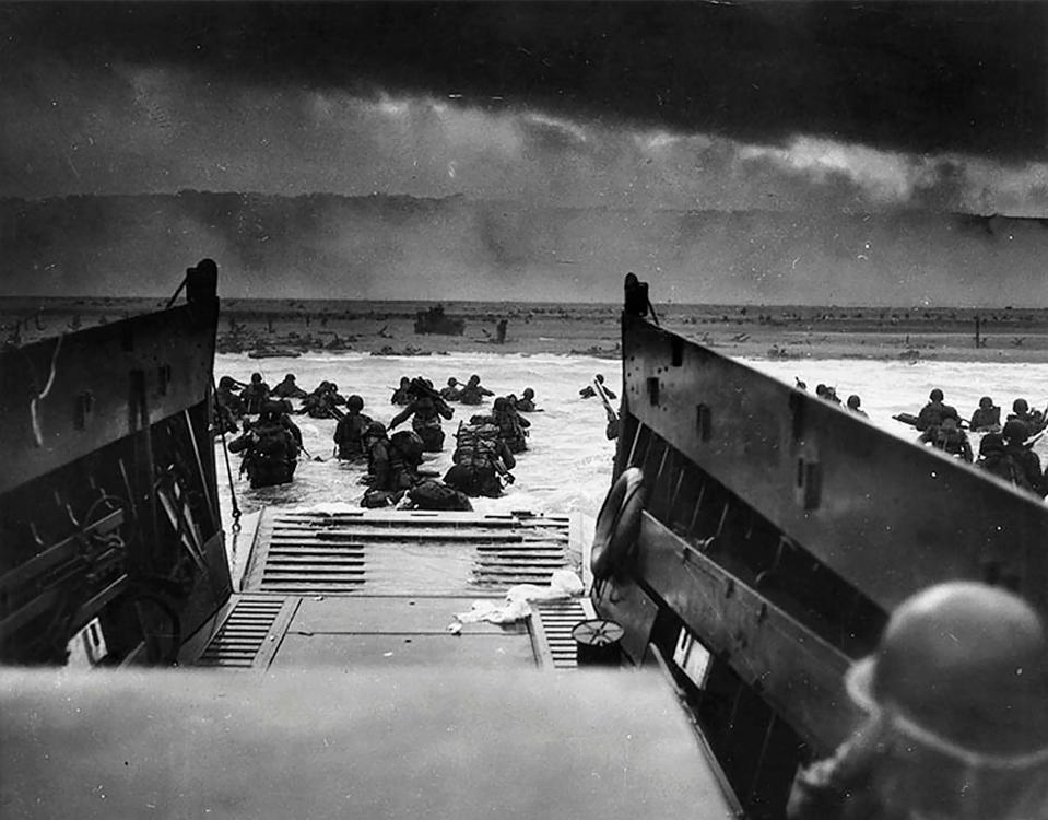 This June 6, 1944, file photo shows U.S. Army troops wading ashore at Omaha Beach in northwestern France during the D-Day invasion.