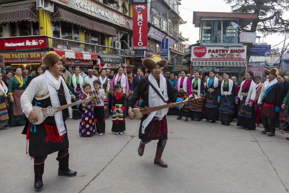 Exile Tibetans perform a traditional communal dance in the town square to celebrate the third day of the Tibetan New Year or Losar in Dharmsala, India, Wednesday, Feb. 26, 2020. (AP Photo/Ashwini Bhatia)