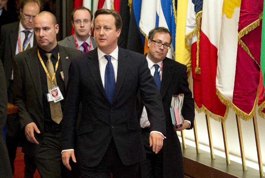 British Prime Minister David Cameron, center, departs after an EU summit in Brussels on Friday, Nov. 23, 2012. The leaders of Britain and France staked out starkly different visions of Europe's future as talks in Brussels on how much the European Union should be allowed to spend, set the stage for a long, divisive and possibly inconclusive summit. (AP Photo/Geert Vanden Wijngaert)