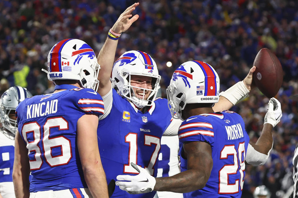 Buffalo Bills quarterback Josh Allen (17) celebrates with teammates after scoring a touchdown against the Dallas Cowboys during the second quarter of an NFL football game, Sunday, Dec. 17, 2023, in Orchard Park, N.Y. (AP Photo/Jeffrey T. Barnes)