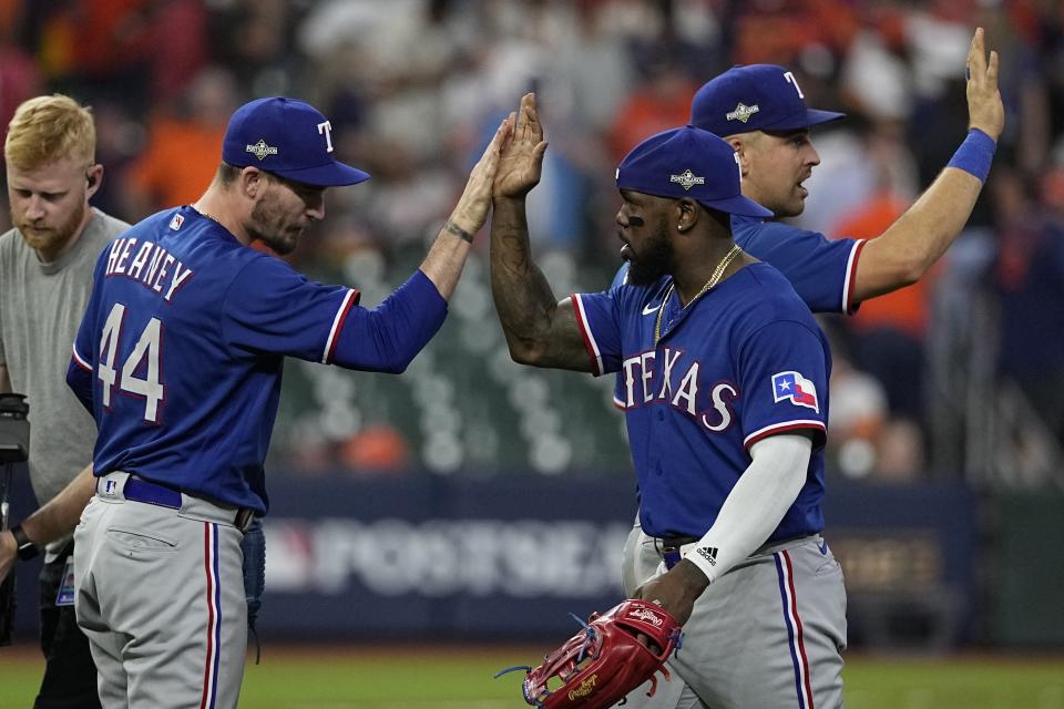 The Texas Rangers celebrate after Game 6 of the baseball AL Championship Series against the Houston Astros Sunday, Oct. 22, 2023, in Houston. The Rangers won 9-2 to tie the series 3-3. (AP Photo/David J. Phillip)