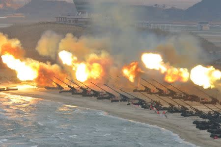 Artillery pieces are seen being fired during a military drill at an unknown location, in this undated photo released by North Korea's Korean Central News Agency (KCNA) on March 25, 2016. REUTERS/KCNA/File Photo