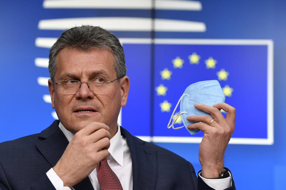 European Commission Vice-President Maros Sefcovic removes his protective face mask prior to speaking during a media conference, after a General Affairs Council meeting, at the European Council building in Brussels, Tuesday, Feb. 23, 2021. (John Thys, Pool via AP)