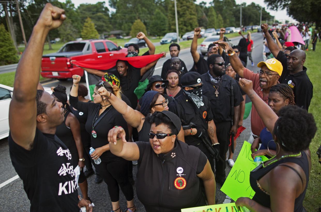 Members of the New Black Panther Party march in front of the Baton Rouge Police Department headquarters in Baton Rouge, La., Saturday, July 9, 2016, in support of justice for Alton Sterling, who was killed by police Tuesday. (AP Photo/Max Becherer)