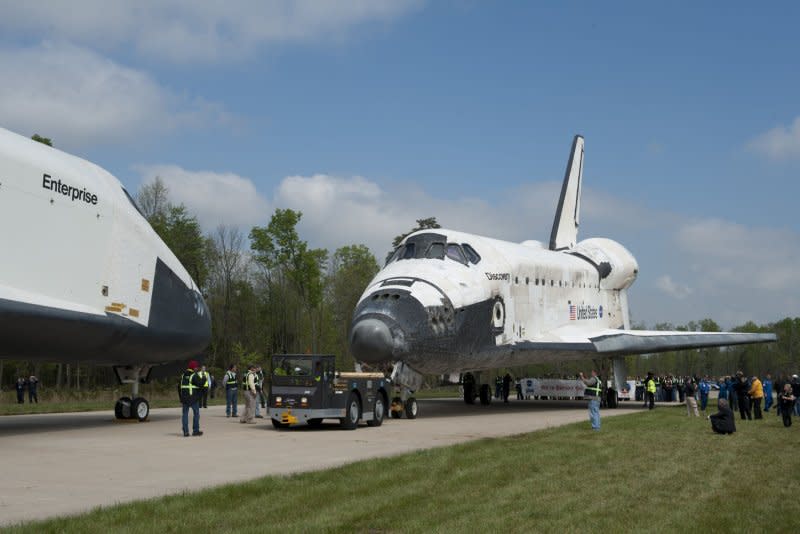 Space shuttle Discovery is towed nose-to-nose with space shuttle Enterprise during a transfer ceremony at the Smithsonian's National Air and Space Museum's Udvar-Hazy Center in Chantilly, Va., on April 19, 2012. On March 28, 2009, the space shuttle Discovery landed at the Kennedy Space Center in Florida after a 13-day mission to the International Space Station during which the ISS was brought up to full power with the installation of its fourth set of solar wings. File Photo by Kevin Dietsch/UPI