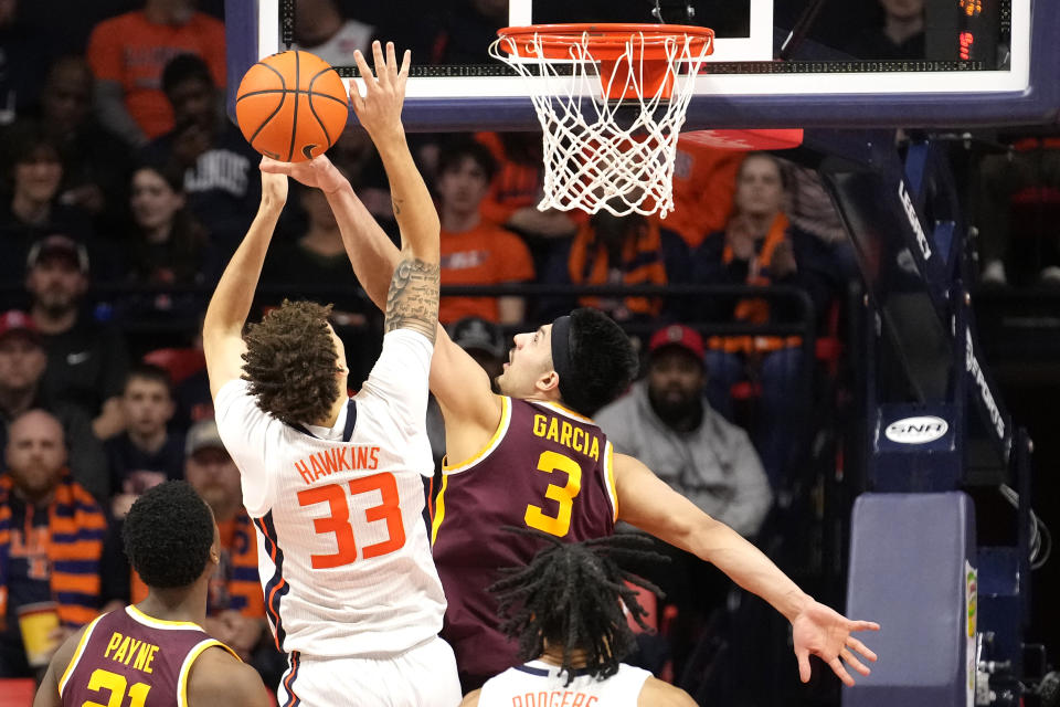 Minnesota' Dawson Garcia (3) blocks the shot of Illinois' Coleman Hawkins during the second half of an NCAA college basketball game Wednesday, Feb. 28, 2024, in Champaign, Ill. Illinois won 105-97. (AP Photo/Charles Rex Arbogast)