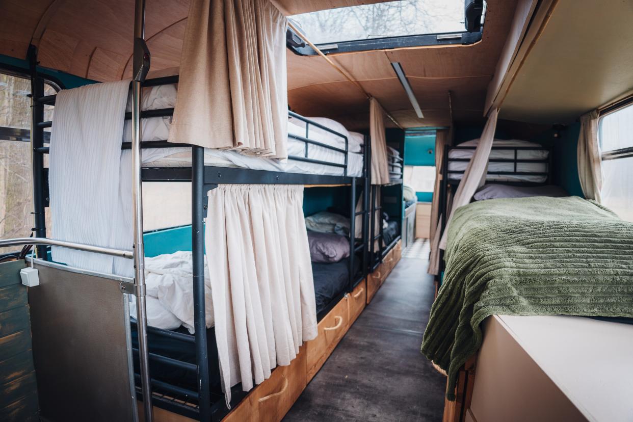 bunk beds inside a converted double-decker bus