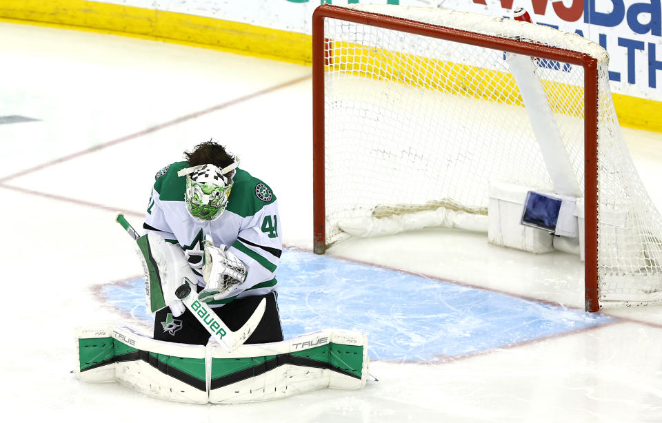 Dallas Stars goaltender Scott Wedgewood (41) reacts after a save that hit his face mask during the third period of an NHL hockey game against the New Jersey Devils, Saturday, Jan. 20, 2024, in Newark, N.J. (AP Photo/Noah K. Murray)