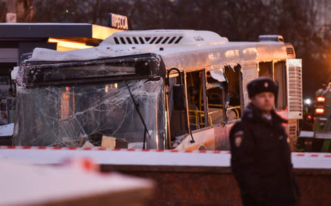 Rescuers worked to pull the bus out - Credit: AFP